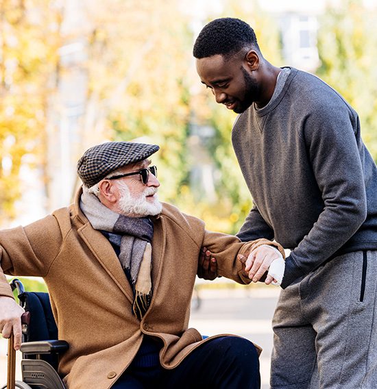 Man helping an elderly gentleman