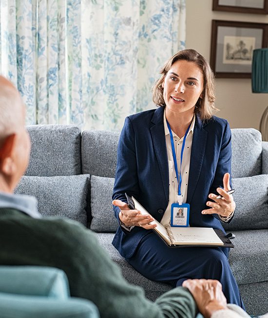 Woman Speaking with Elderly Couple<br />
