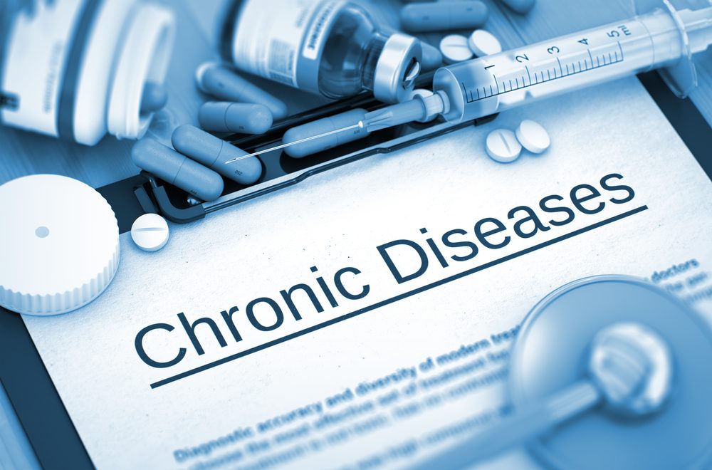 Chronic Diseases on Background of Medicaments Composition - Pills, Injections and Syringe. Chronic Diseases - Printed Diagnosis with Blurred Text.