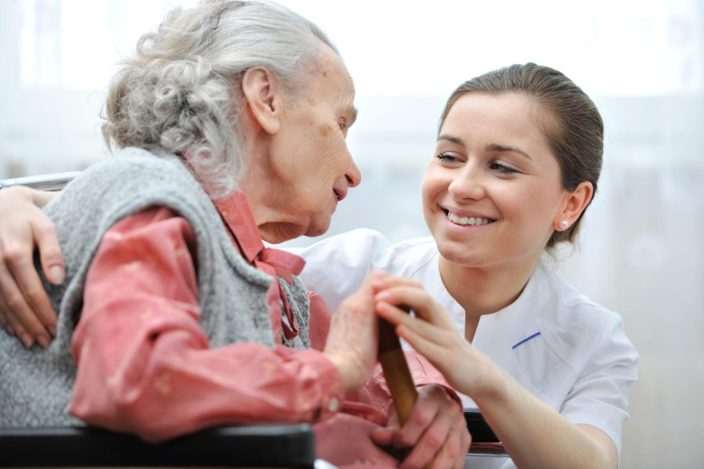 Senior woman with her caregiver at Palliative Care
