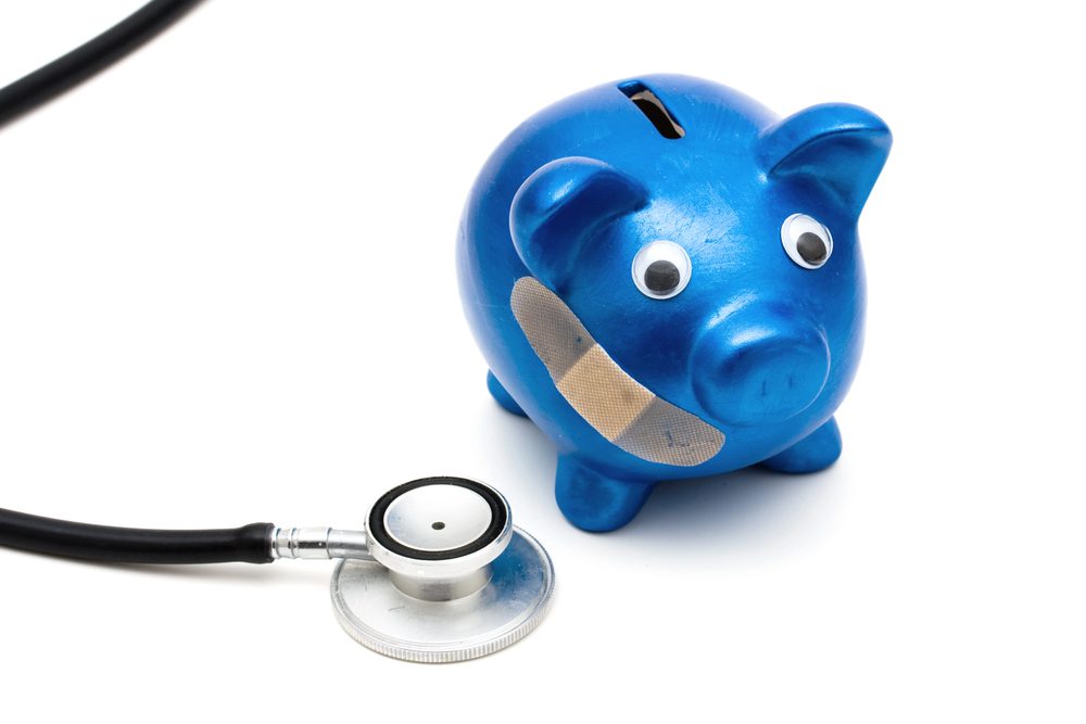 expensive healthcare after 65, broken piggy bank and stethoscope