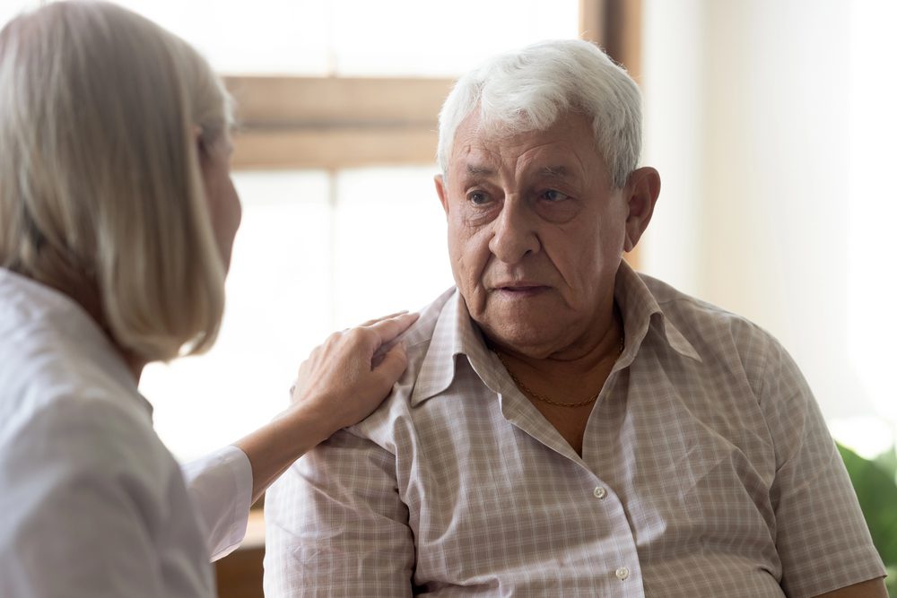 lady speaking to her elderly dad about his abilities